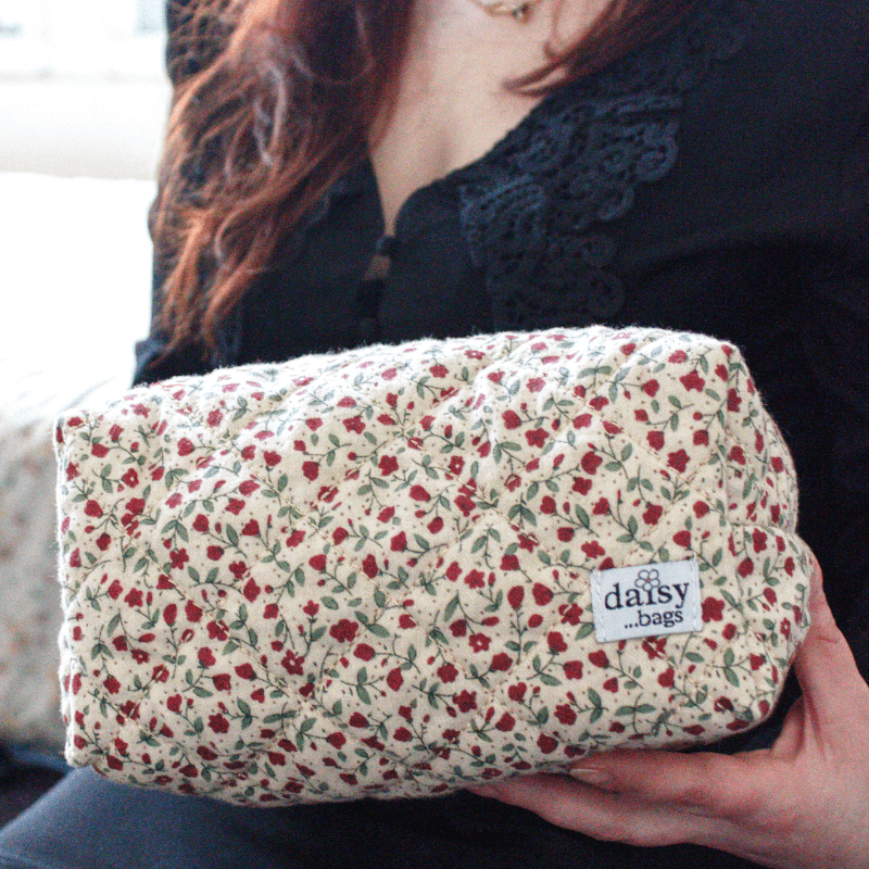 Young women holding a Rose floral makeup bag