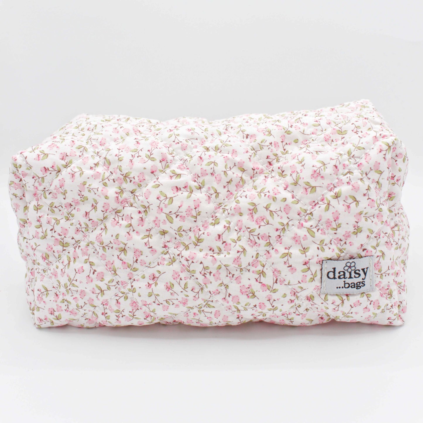 The Daisy floral makeup bag one a grey background