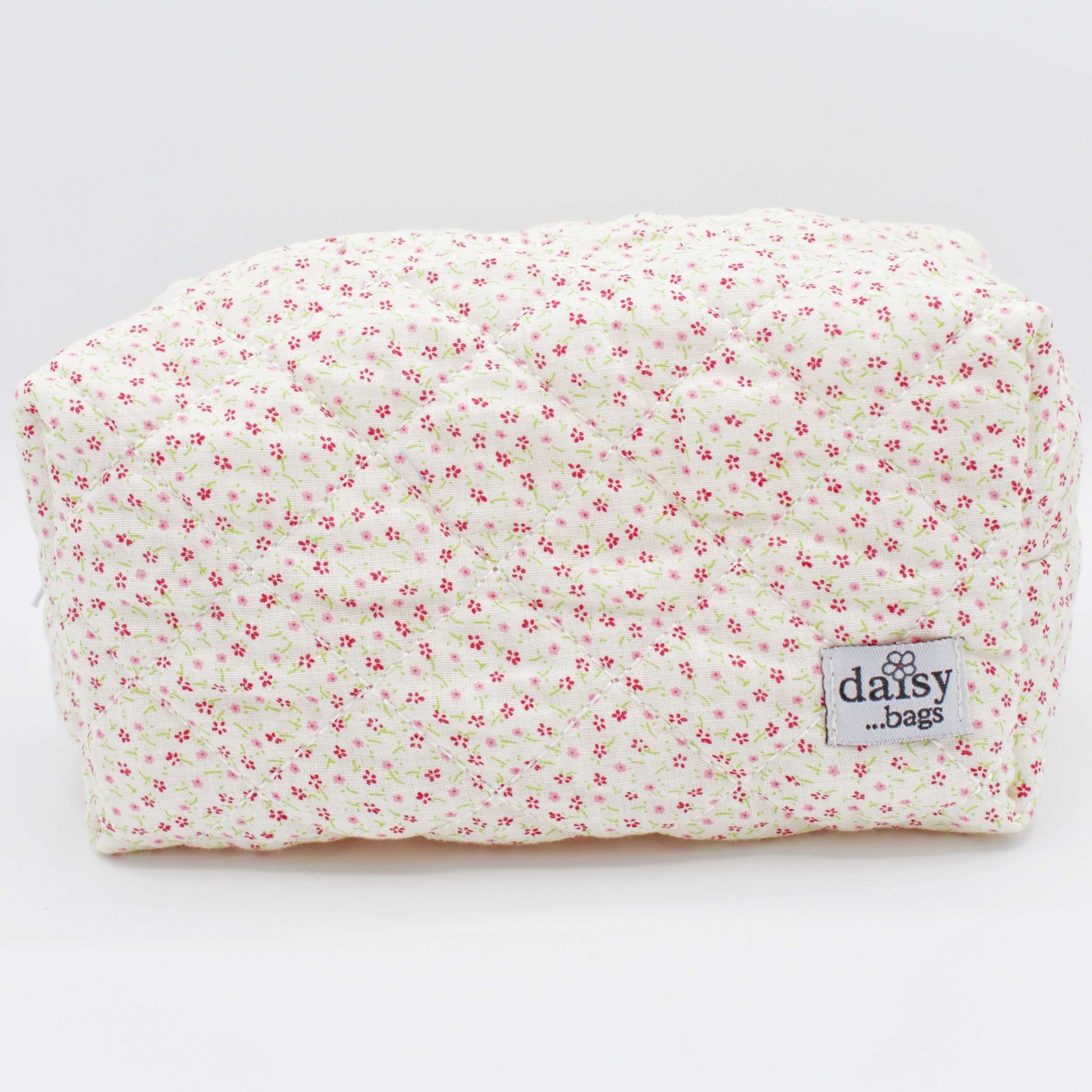 The Bloom floral makeup bag against a grey background