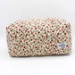The Rose floral makeup bag on a grey background