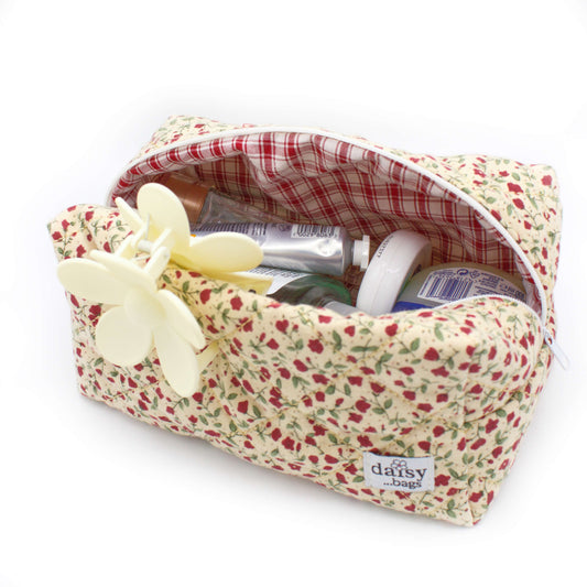 The Rose floral makeup bag on a white background