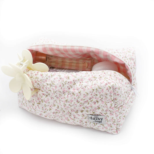 The Daisy floral makeup bag on a white background